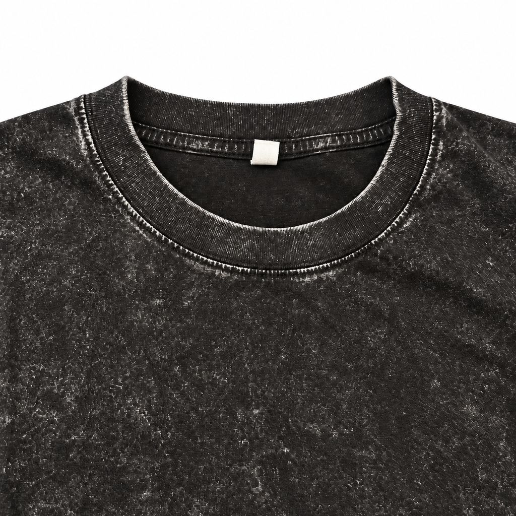 Close-up of the black washed crewneck T-shirt neckline and stitching.